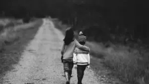 Children walking down a quiet rural road in the New Forest, UK.
