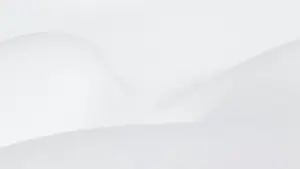 Pristine white snow drifts with soft shadows on a winter day.