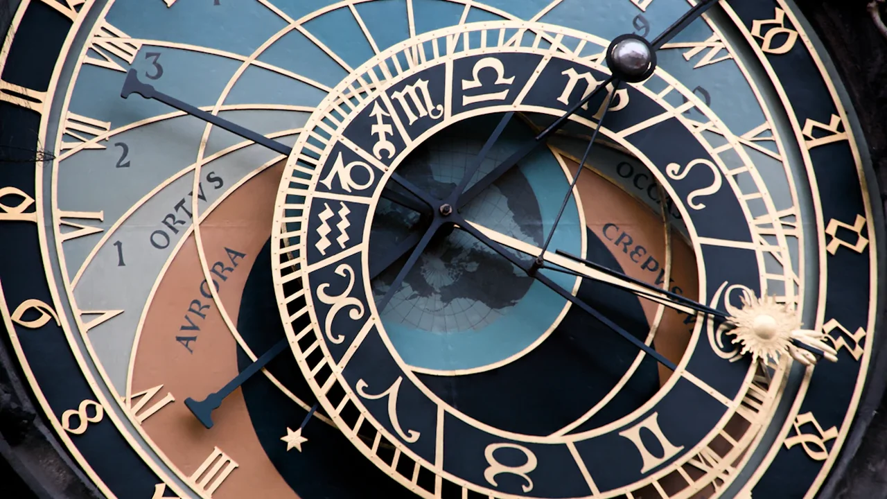 Close-up of the historic Prague astronomical clock dial showing intricate zodiac symbols and details.